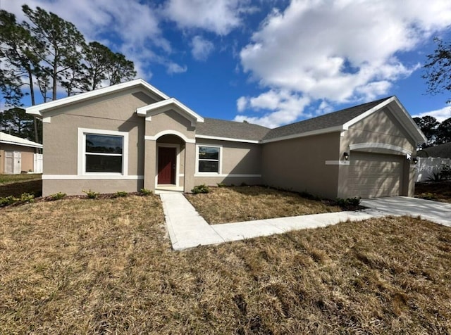 single story home featuring a front yard, concrete driveway, an attached garage, and stucco siding