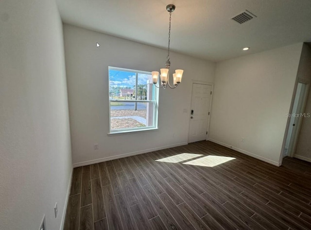 unfurnished dining area with baseboards, visible vents, a chandelier, and dark wood-type flooring