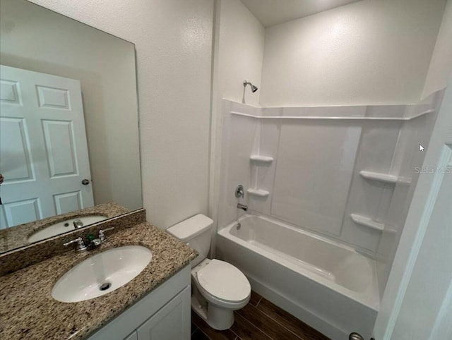 full bathroom with toilet, vanity, tub / shower combination, and wood finish floors