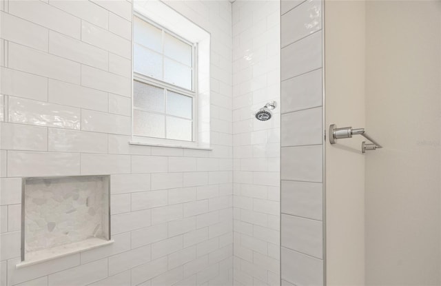 bathroom with tiled shower