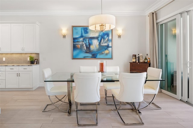 dining space featuring light wood-type flooring and crown molding