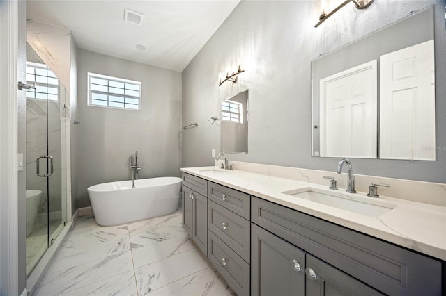 bathroom featuring vanity and separate shower and tub