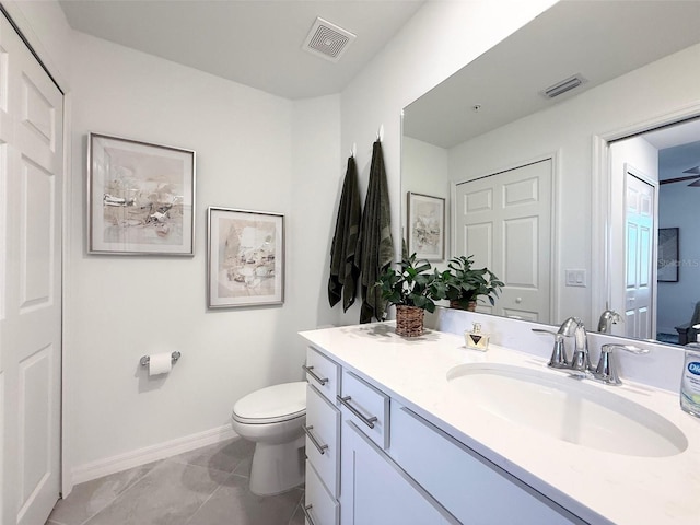 bathroom featuring baseboards, visible vents, vanity, and toilet