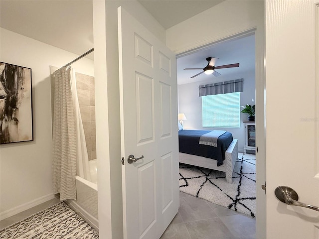 tiled bedroom featuring a ceiling fan and baseboards