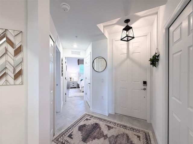 foyer featuring visible vents and baseboards