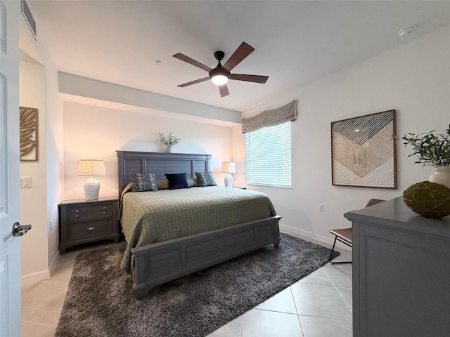 bedroom featuring ceiling fan, baseboards, and light tile patterned floors