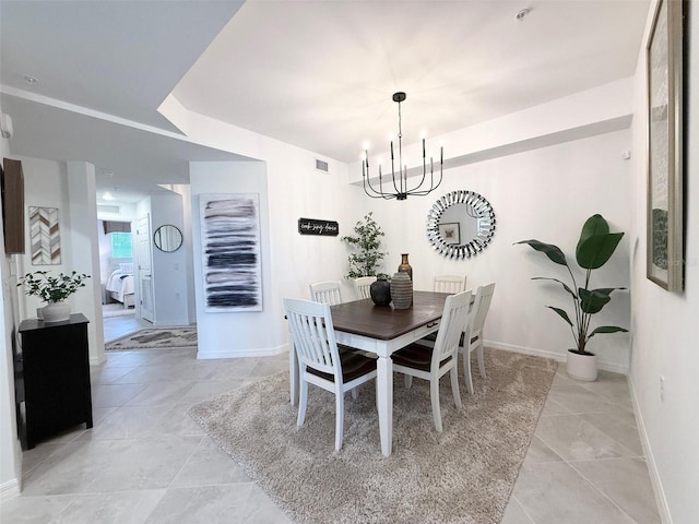 dining room featuring baseboards, visible vents, and an inviting chandelier