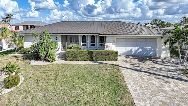 single story home featuring a garage and a front lawn