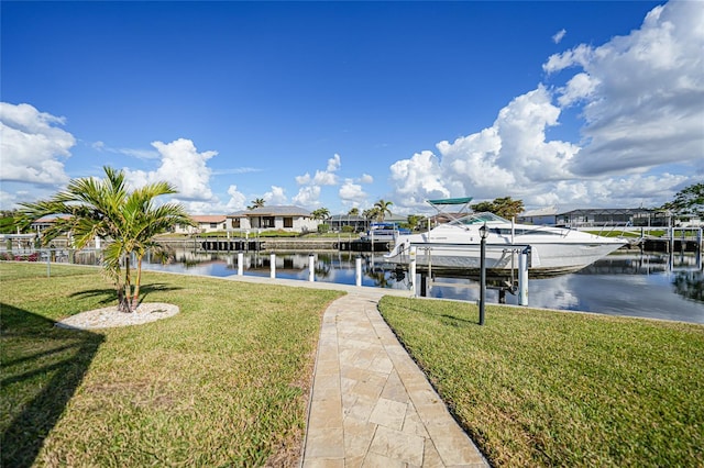 dock area with a lawn and a water view