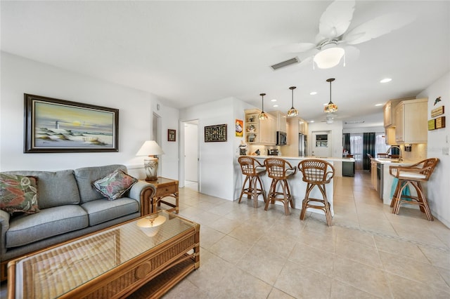 tiled living room featuring ceiling fan