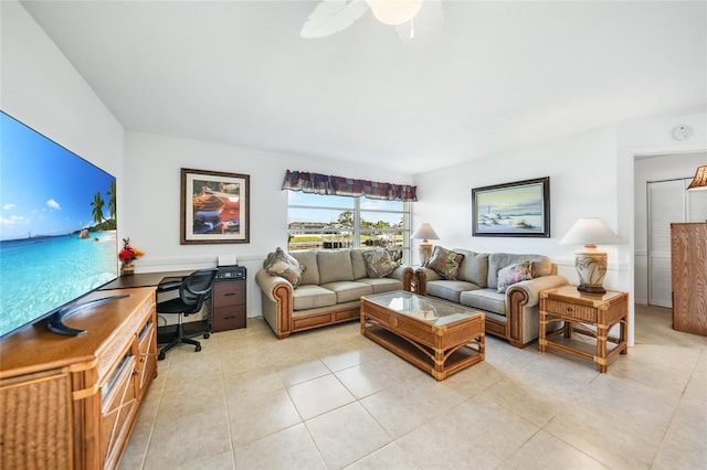 tiled living room with ceiling fan