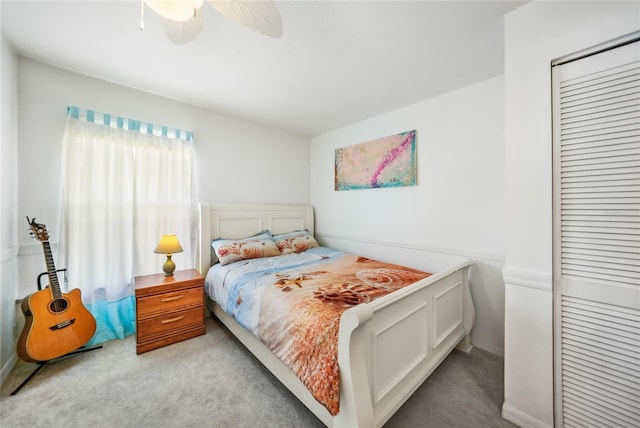 carpeted bedroom with a closet and ceiling fan