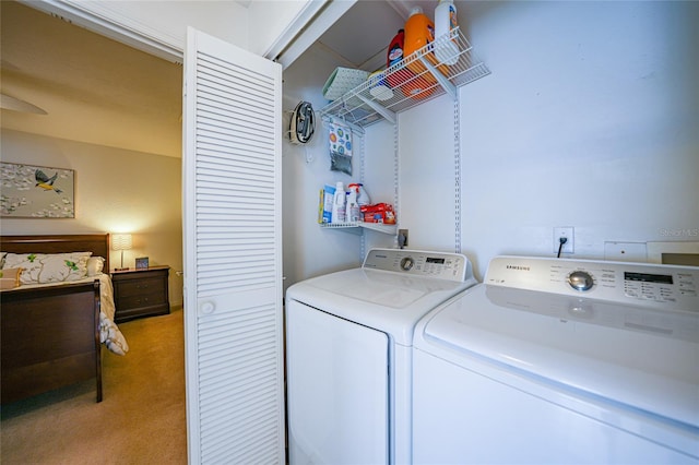 washroom with light carpet and washer and dryer