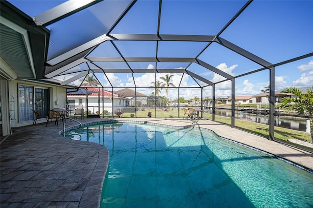 view of pool featuring a water view, a patio area, and a lanai