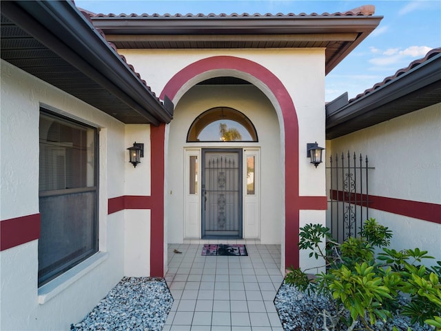 1946 Cove Pointe Dr, Venice, FL 34293 - view of exterior entry with stucco siding and a tile roof