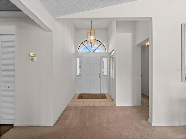 1946 Cove Pointe Dr, Venice, FL 34293 - tiled foyer featuring a chandelier, carpet flooring, and lofted ceiling