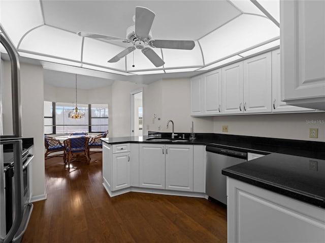 kitchen featuring sink, dark wood-type flooring, stainless steel dishwasher, white cabinets, and ceiling fan with notable chandelier