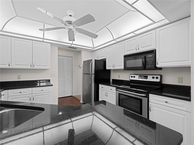 kitchen featuring dark stone countertops, white cabinetry, ceiling fan, and stainless steel appliances