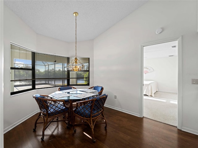1946 Cove Pointe Dr, Venice, FL 34293 - dining room with wood finished floors, a textured ceiling, and lofted ceiling