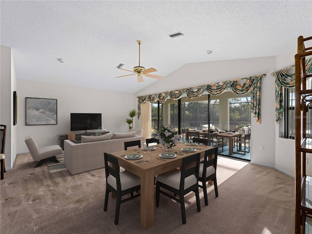 1946 Cove Pointe Dr, Venice, FL 34293 - dining space with light colored carpet, vaulted ceiling, ceiling fan, and a textured ceiling