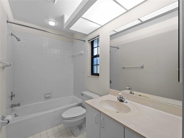 full bathroom featuring toilet, vanity, tile patterned floors, and tiled shower / bath