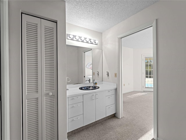 bathroom with vanity and a textured ceiling