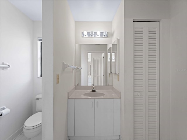 bathroom featuring tile patterned floors, vanity, and toilet