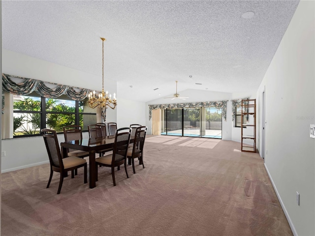 carpeted dining room featuring ceiling fan with notable chandelier and lofted ceiling