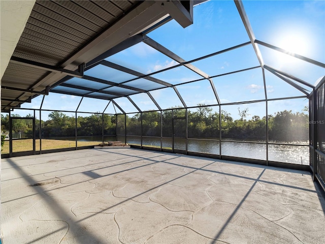 view of patio / terrace with a lanai and a water view