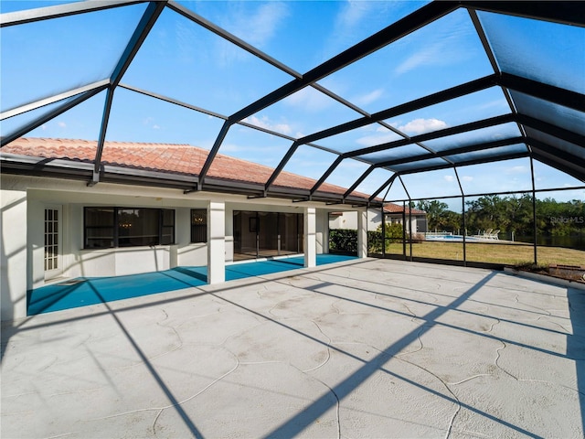 view of swimming pool with glass enclosure and a patio area