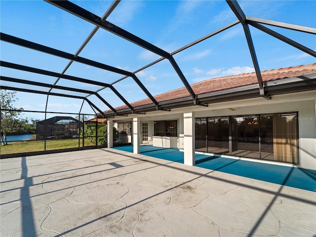 view of swimming pool with glass enclosure and a patio area