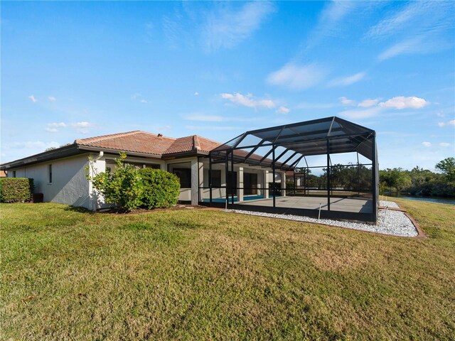 1946 Cove Pointe Dr, Venice, FL 34293 - back of property featuring stucco siding, a tile roof, a yard, a patio area, and a pool