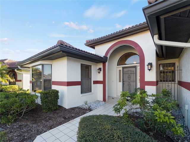 1946 Cove Pointe Dr, Venice, FL 34293 - property entrance with stucco siding and a tiled roof