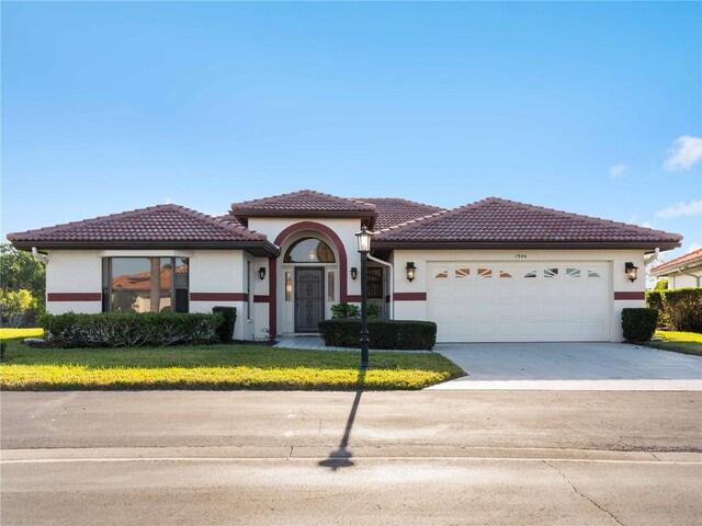 mediterranean / spanish house featuring a garage