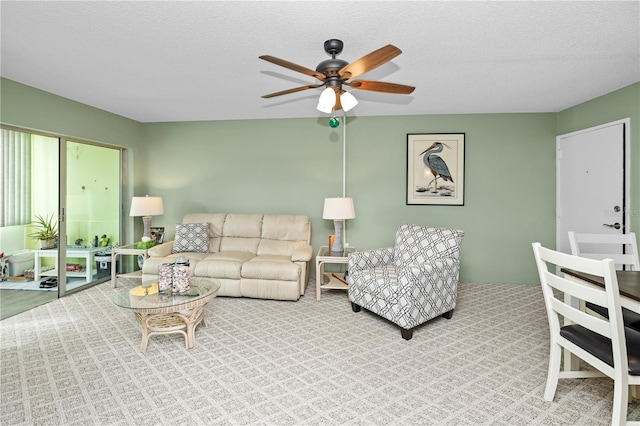 living room with a textured ceiling and ceiling fan