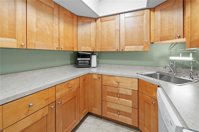 kitchen with dishwasher, light tile patterned flooring, and sink