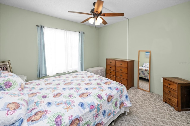 bedroom featuring ceiling fan and light carpet