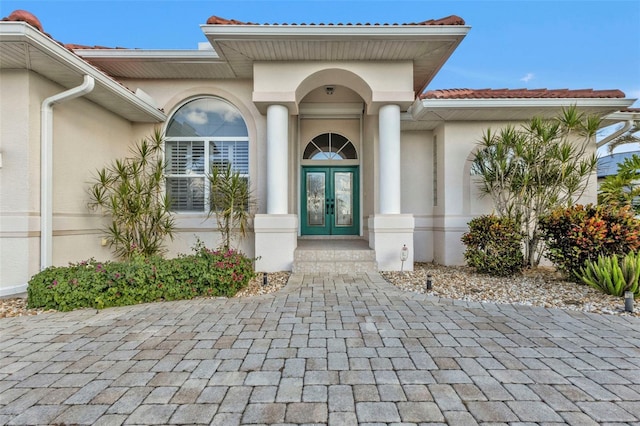 view of exterior entry featuring french doors