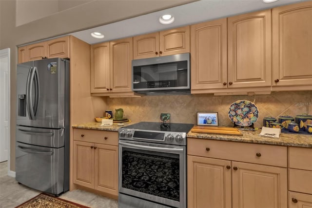 kitchen with decorative backsplash, light stone counters, light brown cabinetry, and appliances with stainless steel finishes