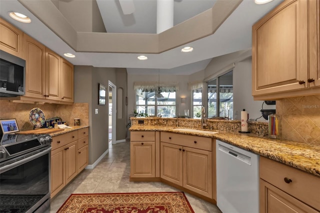 kitchen with light brown cabinets, light tile patterned floors, sink, and appliances with stainless steel finishes