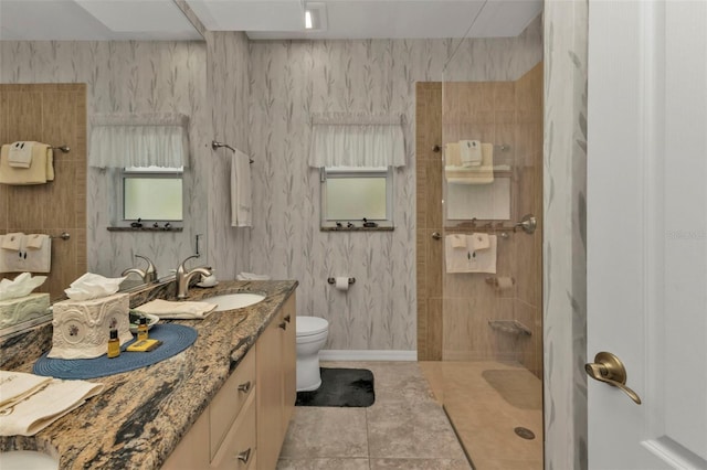 bathroom with tile patterned floors, vanity, toilet, and walk in shower