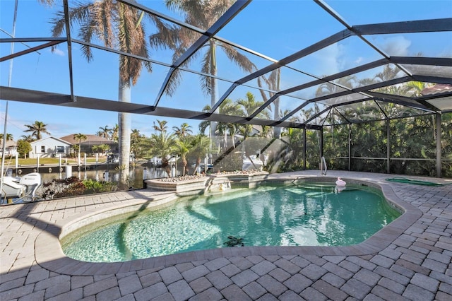 view of pool with glass enclosure and a patio