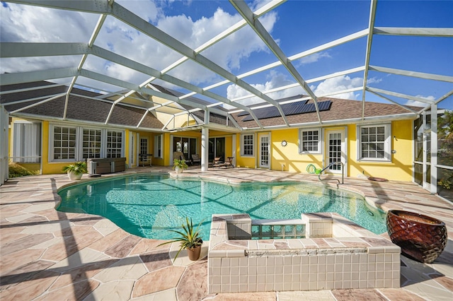 view of pool featuring glass enclosure and a patio area