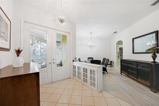 foyer featuring french doors and light hardwood / wood-style flooring