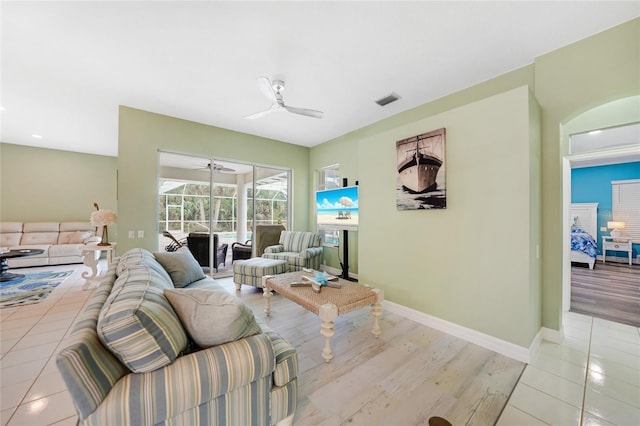 living room with ceiling fan and light wood-type flooring