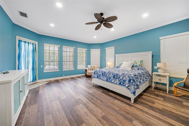 bedroom featuring ceiling fan, dark wood-type flooring, and ornamental molding