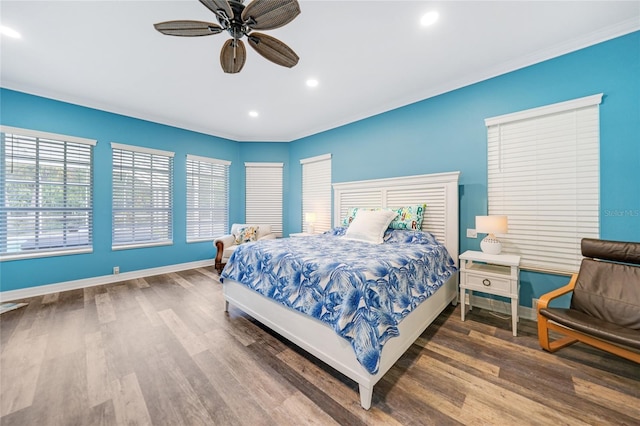 bedroom featuring hardwood / wood-style floors, ceiling fan, and ornamental molding