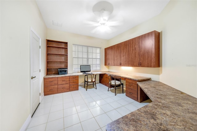 home office featuring light tile patterned floors, built in desk, and ceiling fan