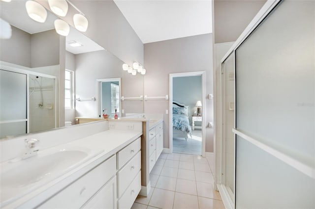 bathroom featuring tile patterned flooring, vanity, and a shower with shower door