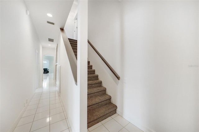 staircase featuring tile patterned floors